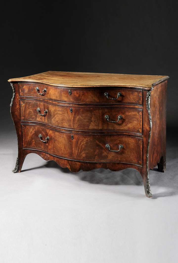 A George III period mahogany serpentine commode Attributed to Henry Hill of Marlborough
